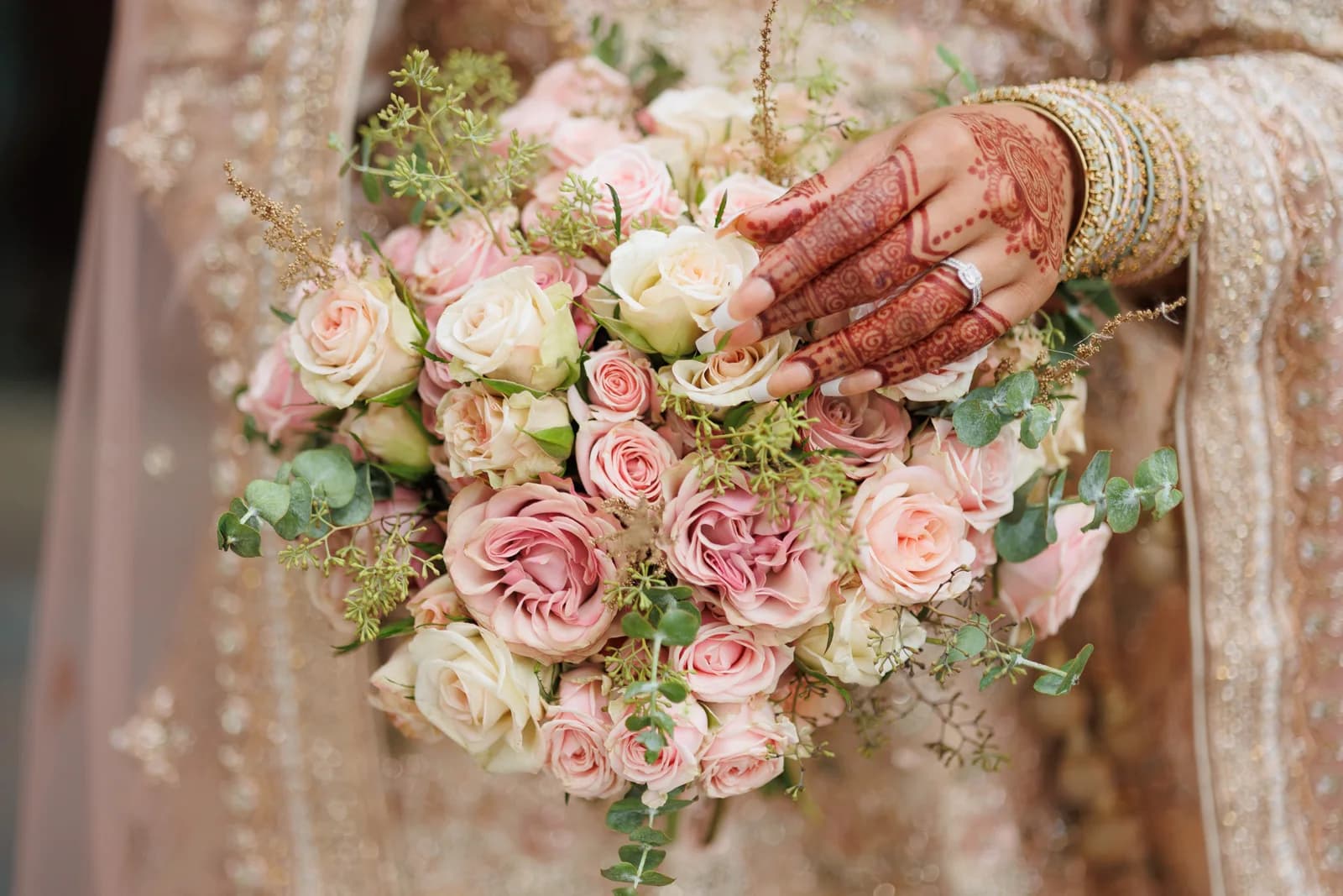 A rose bouquet with bridal jewellery and henna details
