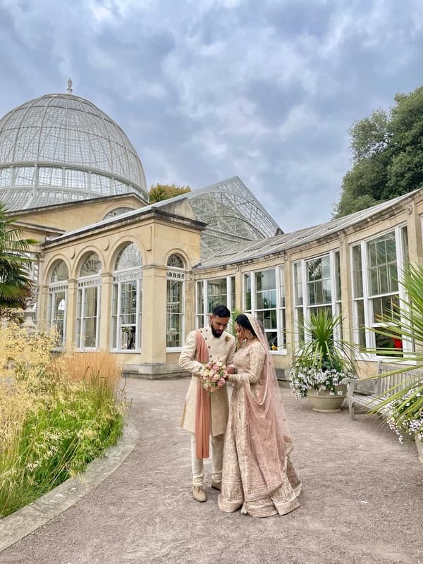 A couple outside a glasshouse